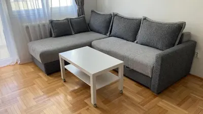 a living room with a couch and a table at Apartman Senjak in Pirot
