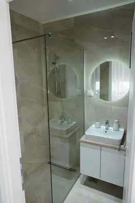 a bathroom with a glass shower and a sink at 