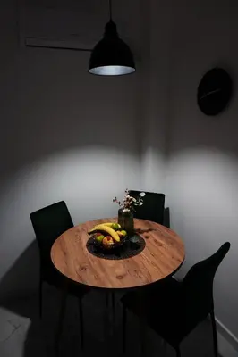 a wooden table with a plate of bananas on it at 