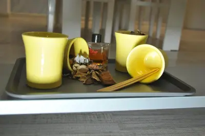 a tray with yellow candles and chopsticks on a table at 
