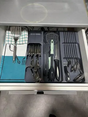 a drawer filled with utensils in a kitchen at 4 Rooms Apartments in Niš