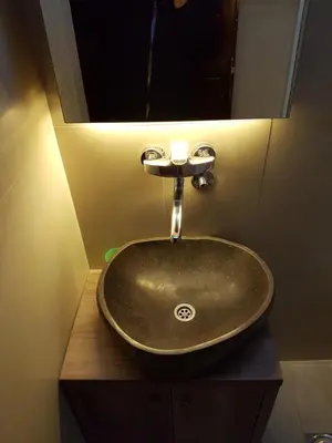 a sink in a bathroom with a mirror at Vila NADJA in Kopaonik