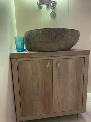 a bathroom sink sitting on top of a wooden cabinet at Vila NADJA in Kopaonik