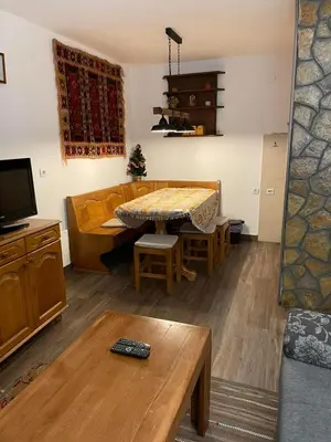 a living room with a couch and a table at Vila NADJA in Kopaonik