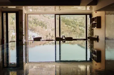 a room with a large window with a view of a lake at Apartment Unna in Kopaonik