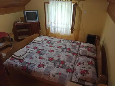 a bed with a quilt on it in a bedroom at Kod Dace in Banja Topilo