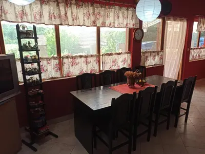 a dining room with a table and chairs and a window at Kod Dace in Banja Topilo