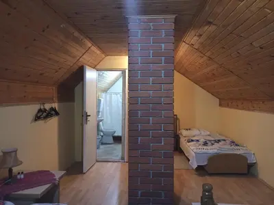 a room with a bed and a brick wall at Kod Dace in Banja Topilo
