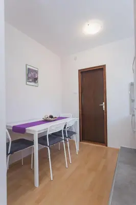 a dining room with a white table and chairs at Guest House SokoDream in Soko Banja