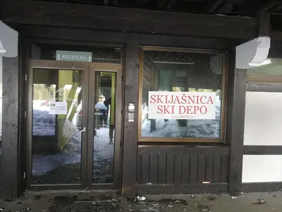 a sign on the door of a shop with a sign in the window at Apartments MARAS - Angella Konaci in Kopaonik
