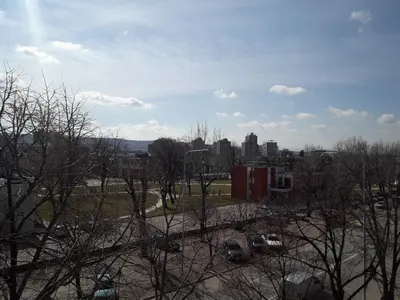 a view of a city with cars parked in a parking lot at Prenoćište Konstantin 2008 in Niš