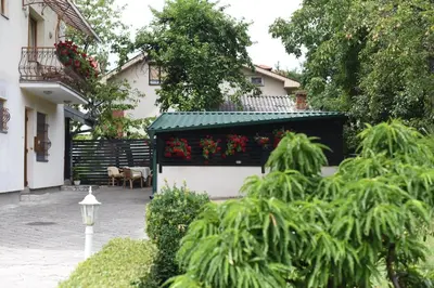 a building with a flower box on the side of it at Apartmani Boss in Vrnjačka Banja