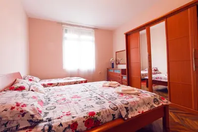 a bedroom with a bed and a dresser at Apartment Sofija in Niš