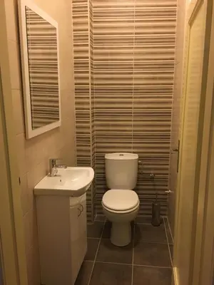 a small bathroom with a toilet and a sink at Apartment Sofija in Niš