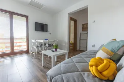 a living room with a bed and a table at Zeleno srce in Soko Banja