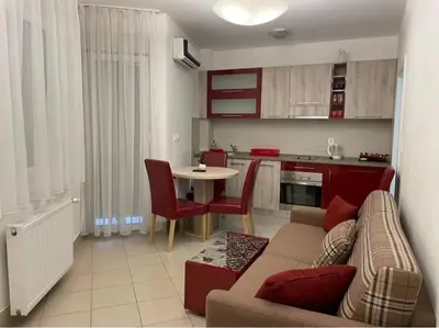 a living room with a couch and a table at Holiday Wing Apartment 2 in Jagodina