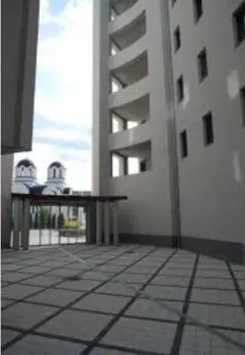 a balcony with a table and a building at Holiday Wing Apartment 2 in Jagodina