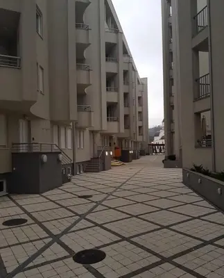 an empty street in an apartment complex with buildings at Holiday Wing Apartment 2 in Jagodina