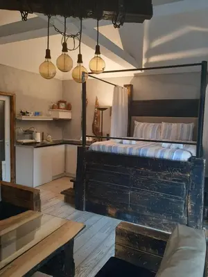 a bedroom with a bed and a table and lights at Apartment Mia in Vrnjačka Banja