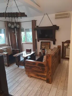 a living room with a large bed and a table at Apartment Mia in Vrnjačka Banja