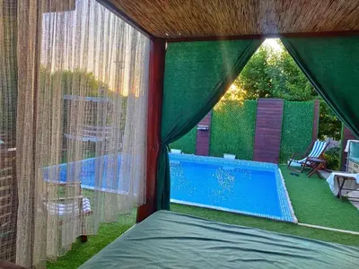 a tent with a swimming pool in a backyard at Villa Saturea in Boljevac