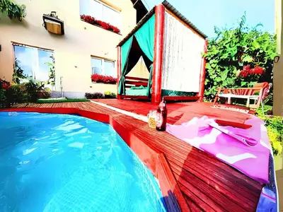 a swimming pool in a backyard with a house at Villa Saturea in Boljevac