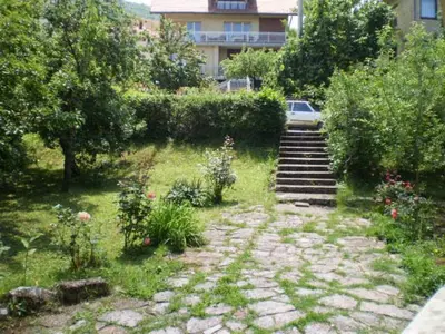 a garden with stairs and flowers and a building at Studio Elizabeta in Soko Banja