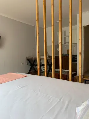 a bedroom with a bed and a balcony at Comfy Studio - 1 minute walk to Delta Planet in Niš