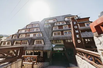 a building with a sign that reads komed at Studio Unna in Kopaonik