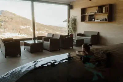 a woman in a bath tub in a hotel room at Studio Unna in Kopaonik