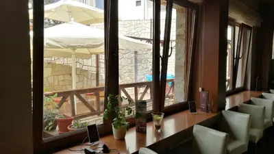 a table and chairs in a room with a window at Studio Unna in Kopaonik