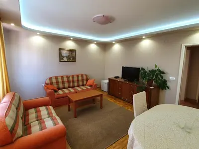 a living room with a couch and a tv at Kompleks Fontana in Vladičin Han