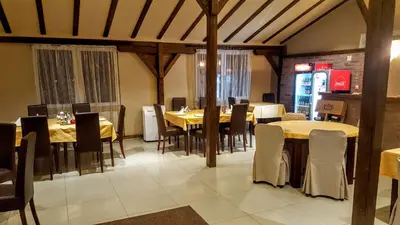a dining room with tables and chairs in a restaurant at Kompleks Fontana in Vladičin Han