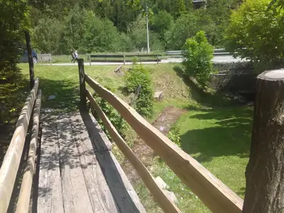 a wooden fence next to a park with trees at Vikend kuca Bela Reka in Brzeće