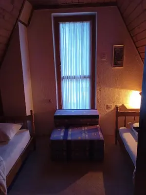 a small room with two beds and a window at Vikend kuca Bela Reka in Brzeće
