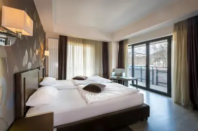 a hotel room with two beds and a large window at Hotel Stara Planina in Ćuštica