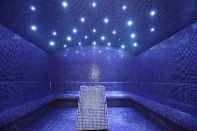 a blue room with a staircase in the middle at Hotel Stara Planina in Ćuštica