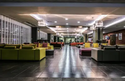 a lobby with couches and chairs in a building at Hotel Stara Planina in Ćuštica
