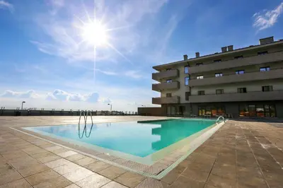 a swimming pool in front of a building at Hotel Stara Planina in Ćuštica