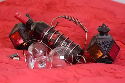 a bunch of wine glasses and a lamp on a red blanket at Zafir 1 in Vrnjačka Banja