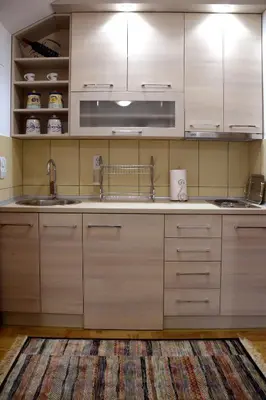 a kitchen with wooden cabinets and a sink at Zafir 1 in Vrnjačka Banja