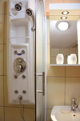 a shower in a bathroom with a sink at Zafir 1 in Vrnjačka Banja