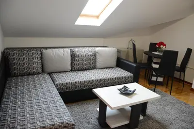 a living room with a couch and a table at Zafir 1 in Vrnjačka Banja
