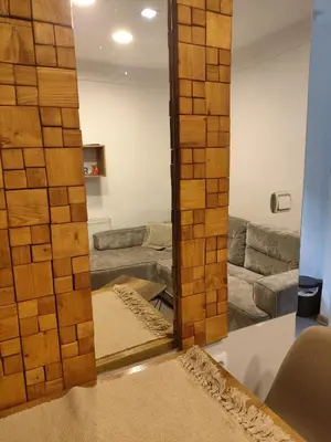 a mirror in a living room with a couch at Garmani in Vrnjačka Banja
