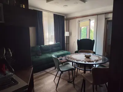 a living room with a green couch and a table at Garmani in Vrnjačka Banja