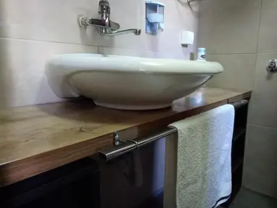 a white sink on a wooden counter in a bathroom at Garmani in Vrnjačka Banja