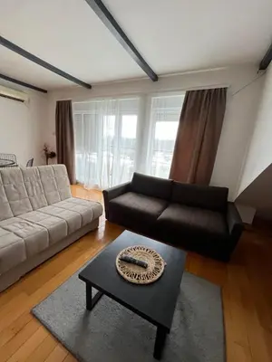 a living room with a couch and a table at Garmani in Vrnjačka Banja