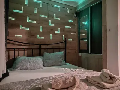 a bedroom with a bed with two towels on it at Garmani in Vrnjačka Banja