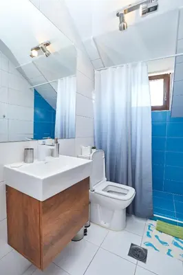 a bathroom with a white sink and a toilet at ŽUPAN apartmani in Soko Banja