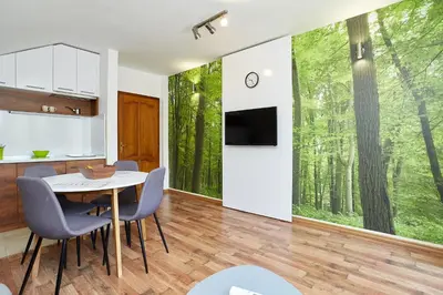 a kitchen and dining room with a table and chairs at ŽUPAN apartmani in Soko Banja